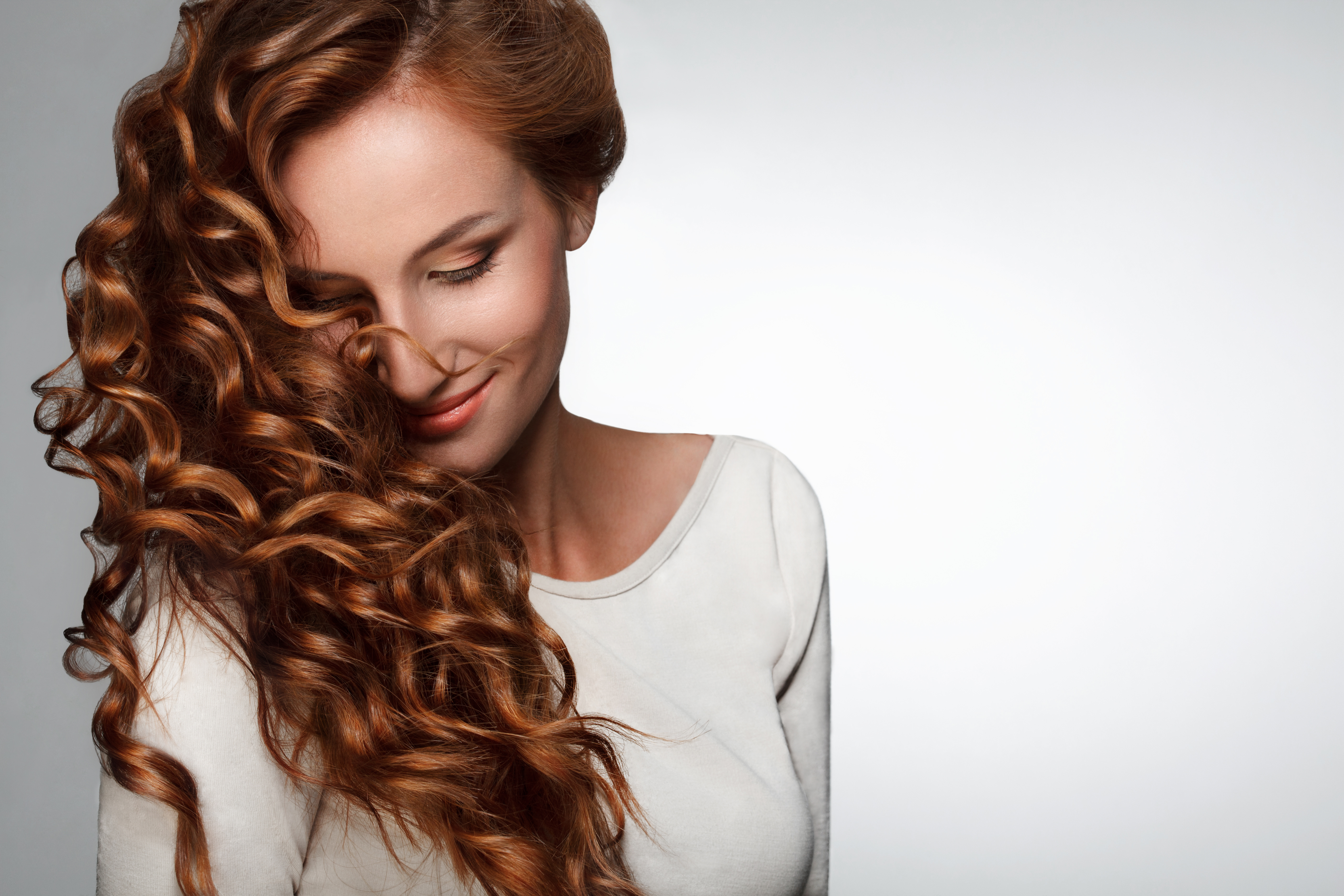 Red Hair. Woman with Beautiful Curly Hair photo
